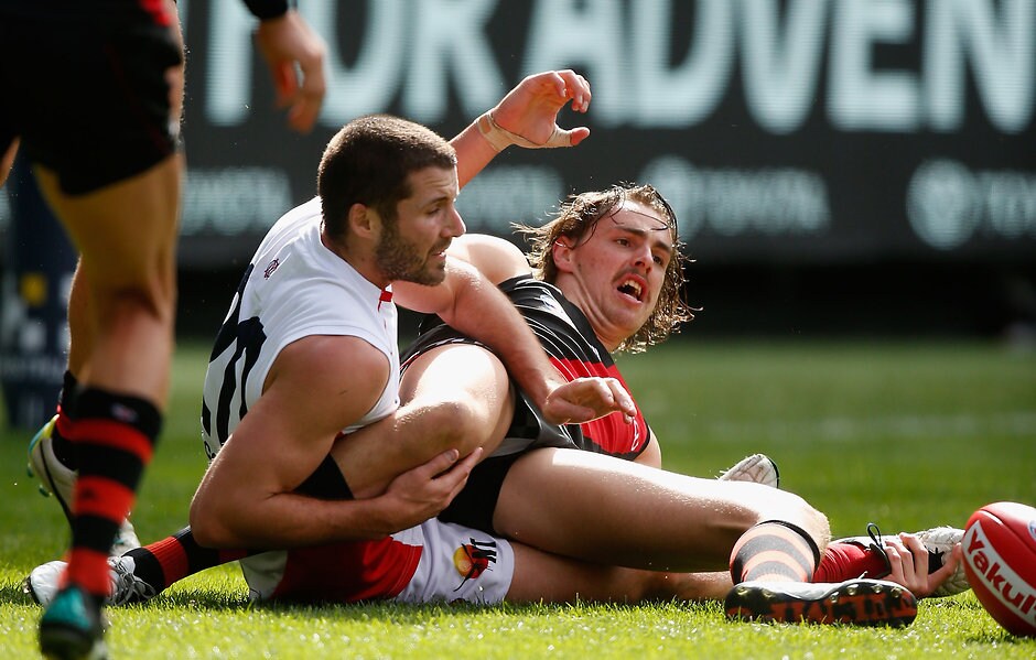 AFL 2016 Rd 02 - Melbourne v Essendon MELBOURNE, AUSTRALIA - APRIL 2: Joe Daniher of the Bombers is tackled by Colin Garland of the Demons during the 2016 AFL Round 02 match between the Melbourne Demons and the Essendon Bombers at the Melbourne Cricket Ground, Melbourne on April 2, 2016. (Photo by Sean Garnsworthy/AFL Media)
